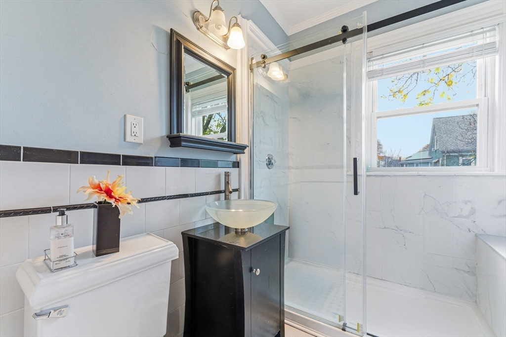 29-31 Essex Avenue, Unit 2 Swampscott, MA 01907 - Photo 11 of 22 a bathroom with a sink and a mirror