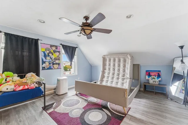 a view of a hallway with paintings on the wall and wooden floor