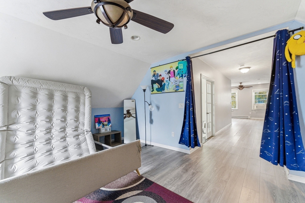 29-31 Essex Avenue, Unit 2 Swampscott, MA 01907 - Photo 19 of 22 a view of a hallway with paintings on the wall and wooden floor