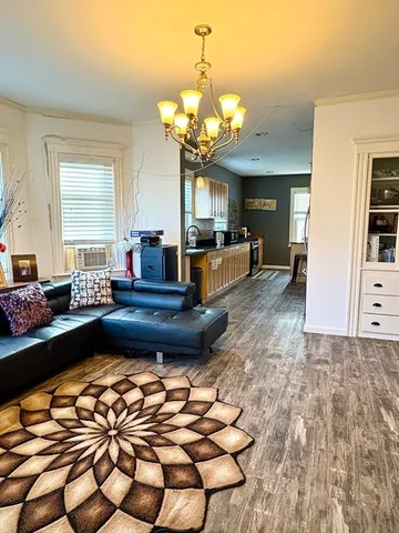 a living room with furniture and a chandelier