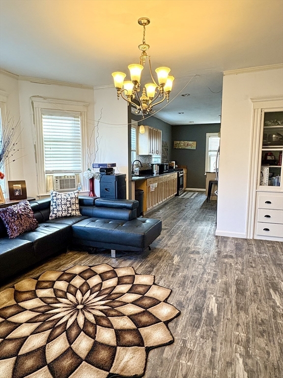 29-31 Essex Avenue, Unit 2 Swampscott, MA 01907 - Photo 3 of 22 a living room with furniture and a chandelier