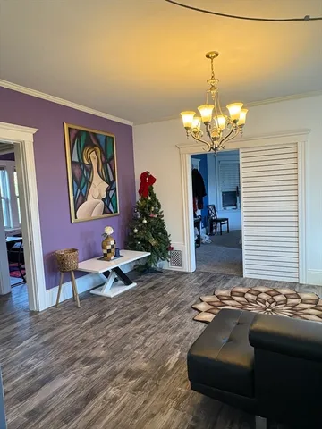 a view of a dining room with furniture wooden floor and chandelier