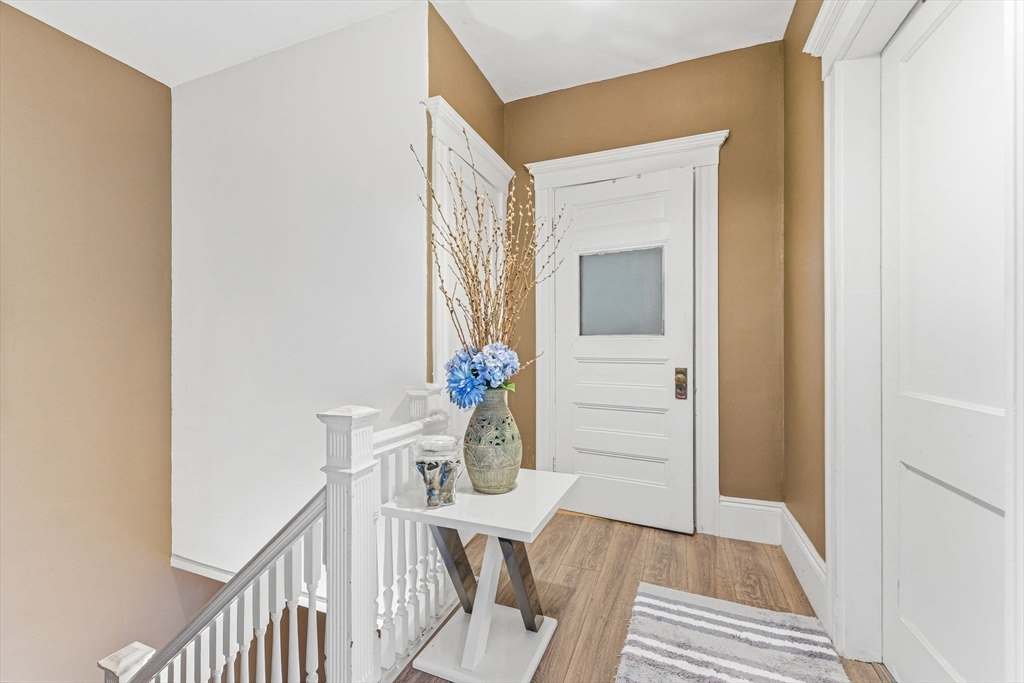 29-31 Essex Avenue, Unit 2 Swampscott, MA 01907 - Photo 6 of 22 a view of a hallway with furniture and wooden floor
