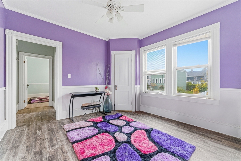 29-31 Essex Avenue, Unit 2 Swampscott, MA 01907 - Photo 9 of 22 a bedroom with a bed and a chandelier