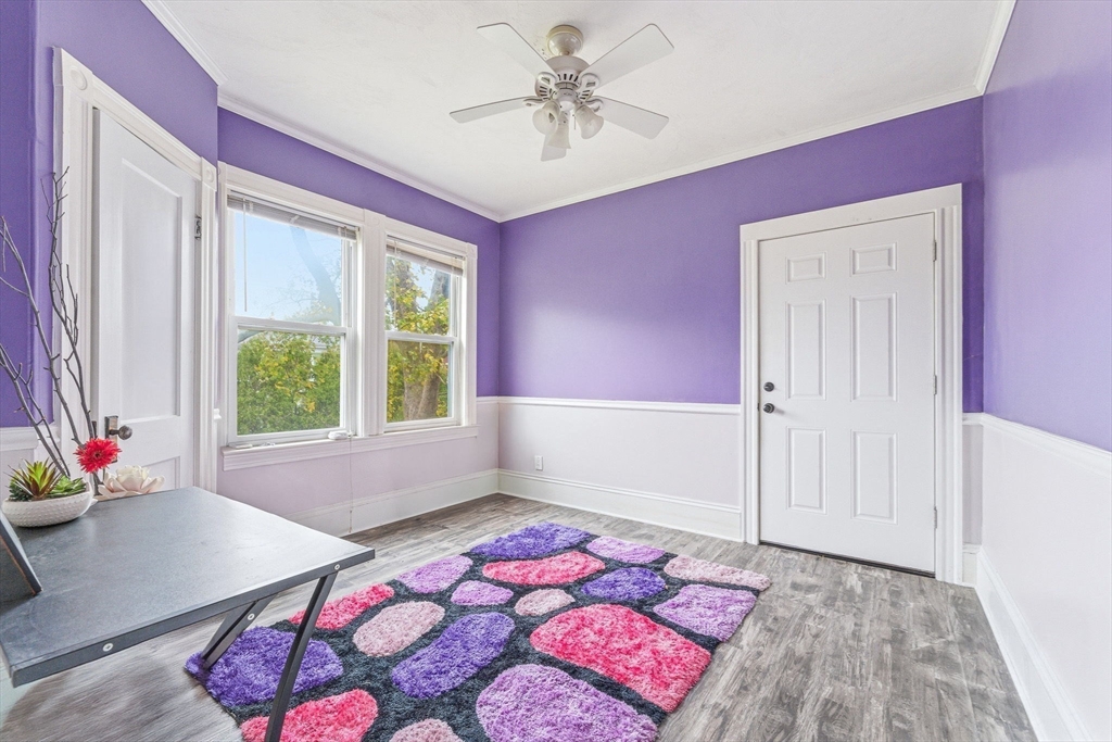 29-31 Essex Avenue, Unit 2 Swampscott, MA 01907 - Photo 10 of 22 a bedroom with a bed and a chandelier