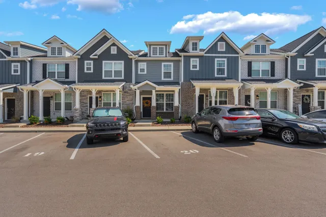 a car parked in front of a white house
