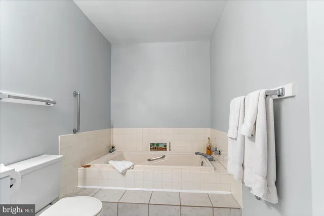 a bathroom with a bathtub and toilet