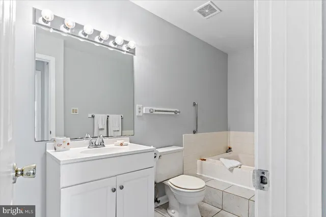a bathroom with a sink toilet and mirror