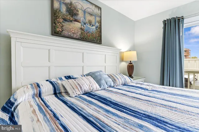 a bedroom with bed and a window