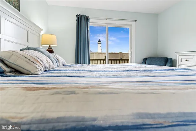 a bedroom with a bed and a lamp