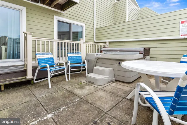 a view of a patio with table and chairs