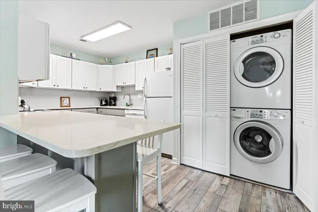 a kitchen with a refrigerator a washer and dryer