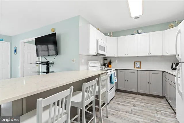 a kitchen with granite countertop a sink and cabinets
