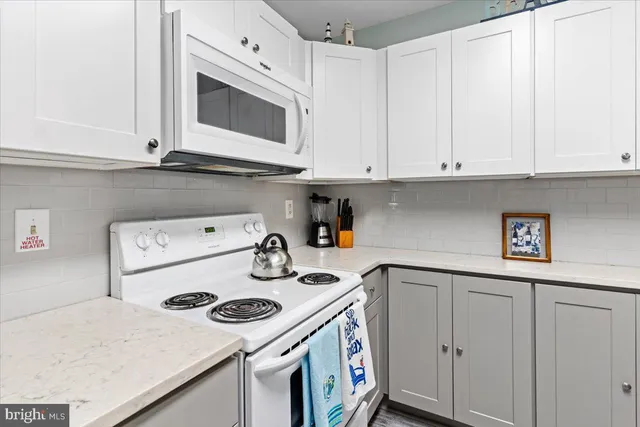 a kitchen with a sink a stove and cabinets