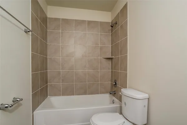 a bathroom with a bathtub and a toilet