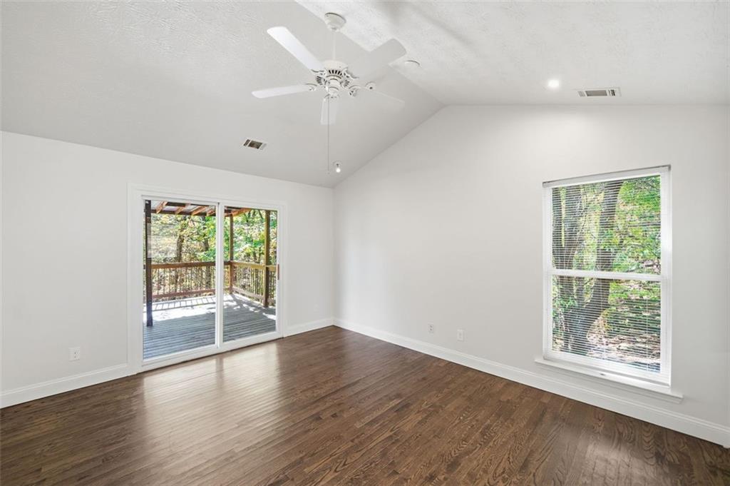 1512 Upper Sassafras Road Jasper, GA 30143 - Photo 19 of 41 an empty room with wooden floor fan and windows