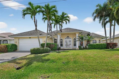 a front view of house with yard and outdoor seating