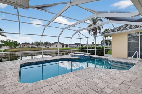 a view of a swimming pool with a chair and couches