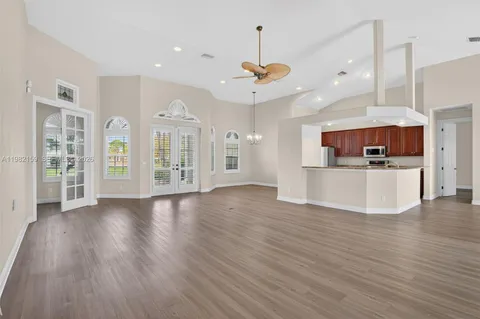 a view of a kitchen with a wooden floor and a kitchen