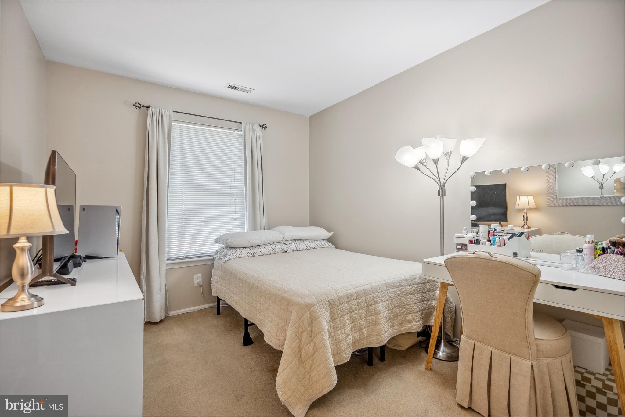 1801A Ralston Drive Mount Laurel, NJ 08054 - Photo 16 of 18 a bedroom with a bed a chandelier and mirror