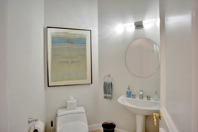 a bathroom with a sink mirror and toilet