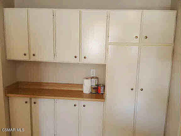 1625 Sequoia Avenue Simi Valley, CA 93063 - Photo 12 of 19 a kitchen with white cabinets and white appliances