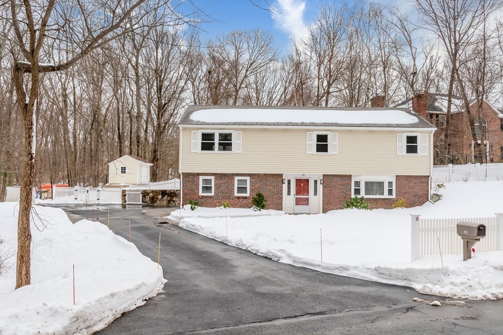 136 Parker Road Framingham, MA 01702 - Photo 1 of 32 a front view of a house with a yard and garage