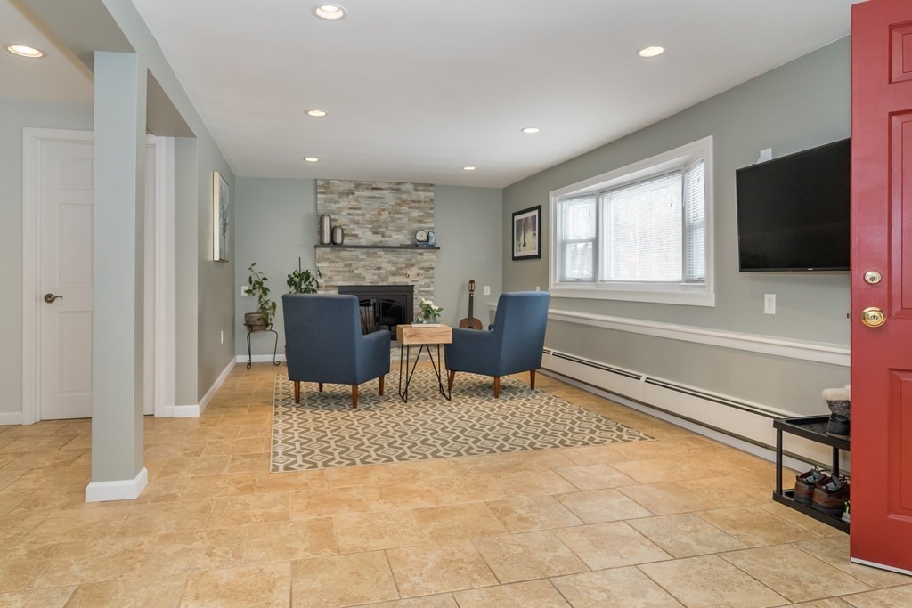 136 Parker Road Framingham, MA 01702 - Photo 15 of 32 a living room with a large window and a flat screen tv