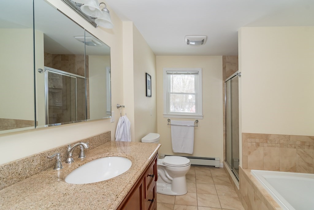 136 Parker Road Framingham, MA 01702 - Photo 21 of 32 a bathroom with a granite countertop sink toilet and shower