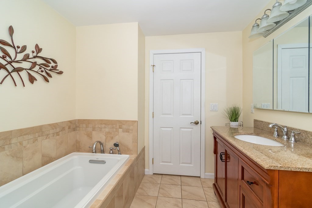 136 Parker Road Framingham, MA 01702 - Photo 22 of 32 a bathroom with a tub sink and mirror