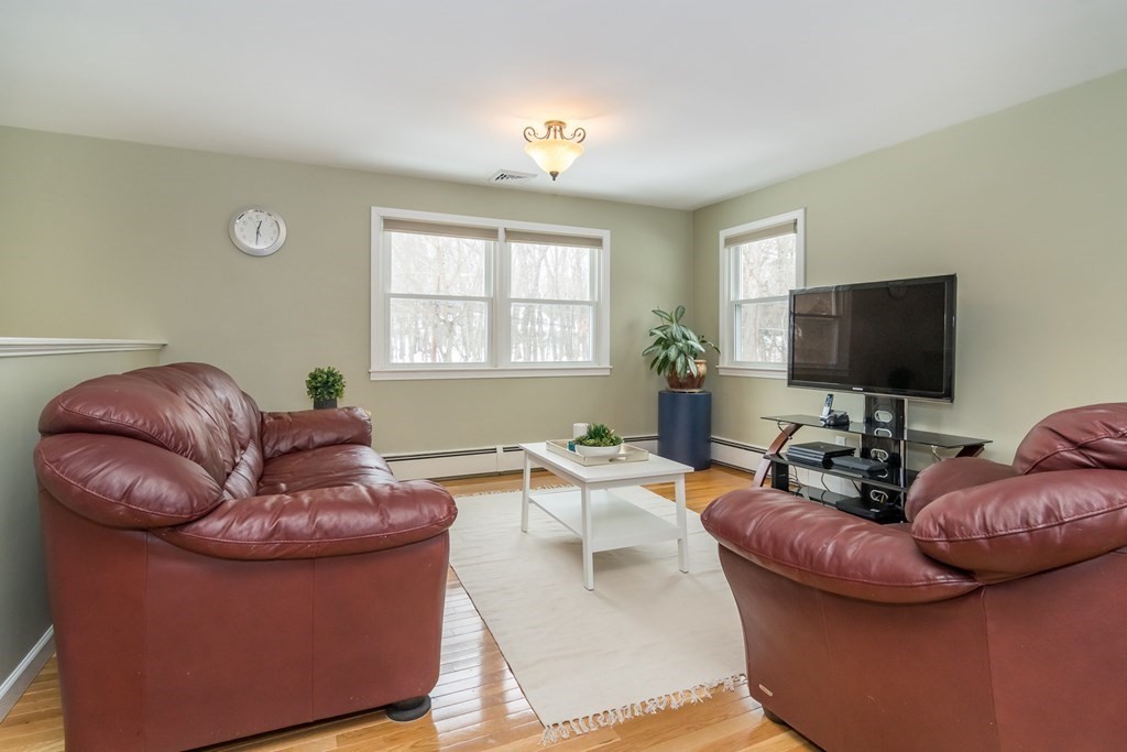 136 Parker Road Framingham, MA 01702 - Photo 8 of 32 a living room with furniture and a flat screen tv