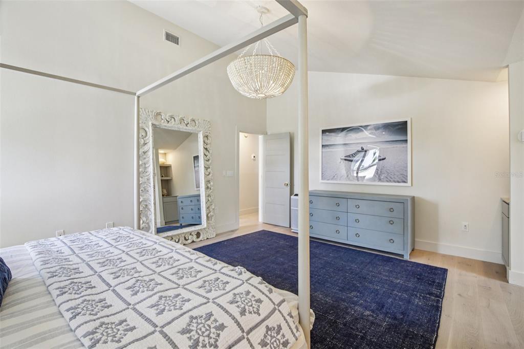 3390 Bayou Sound Longboat Key, FL 34228 - Photo 30 of 59 a bedroom with a bed and a chandelier