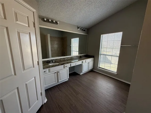 a bathroom with a double vanity sink and mirror