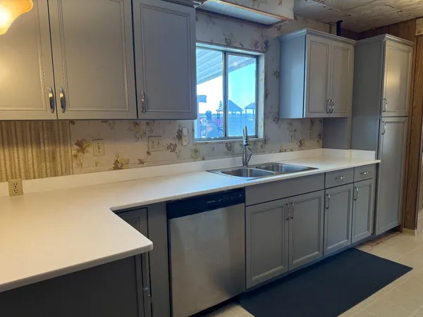 a kitchen with a sink cabinets and window