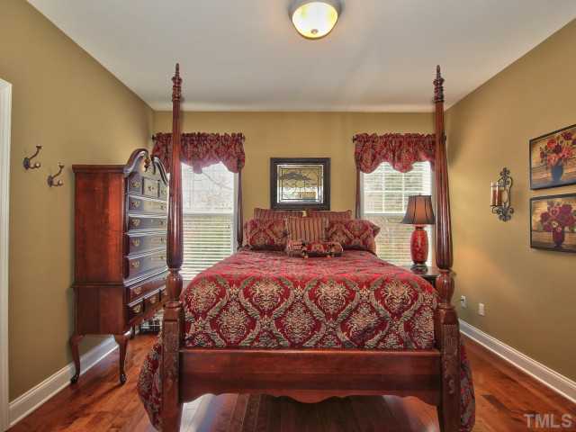 10149 Darling Street Raleigh, NC 27613 - Photo 11 of 25 a bedroom with a bed a dresser and potted plants