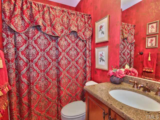 10149 Darling Street Raleigh, NC 27613 - Photo 12 of 25 a bathroom with a sink toilet vanity and shower