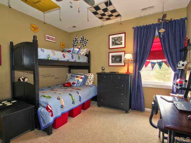 10149 Darling Street Raleigh, NC 27613 - Photo 18 of 25 a bedroom with a bed closet and a window