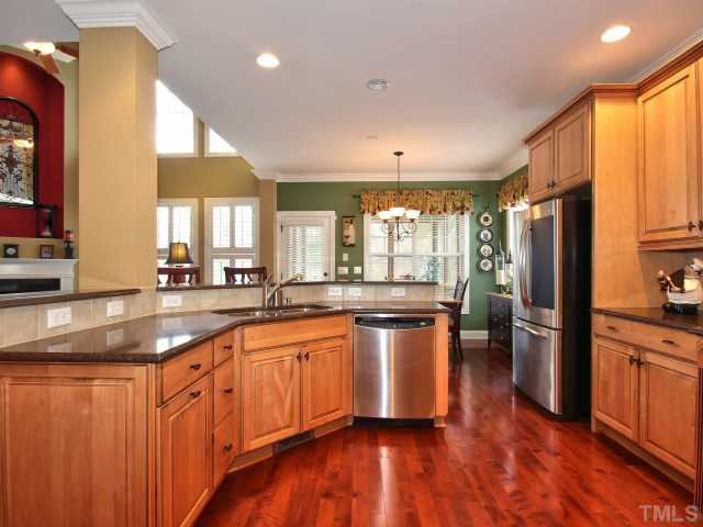 10149 Darling Street Raleigh, NC 27613 - Photo 4 of 25 a kitchen with stainless steel appliances granite countertop a sink a stove and refrigerator