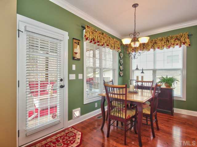 10149 Darling Street Raleigh, NC 27613 - Photo 7 of 25 a view of a dining room with furniture window and wooden floor