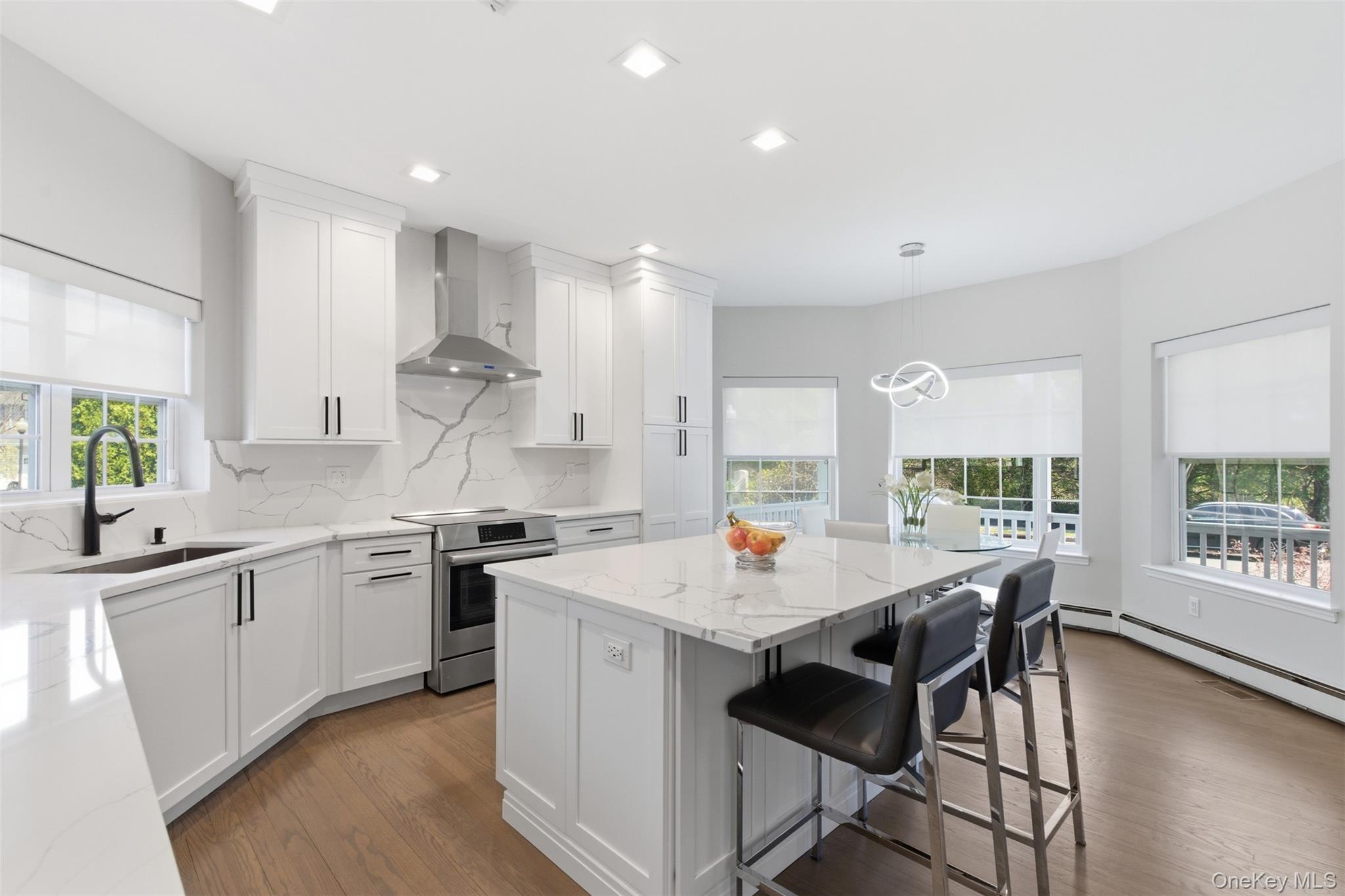 159 Rivendell Court Melville, NY 11747 - Photo 11 of 38 a kitchen with stainless steel appliances granite countertop a stove a sink dishwasher and a refrigerator with wooden floor