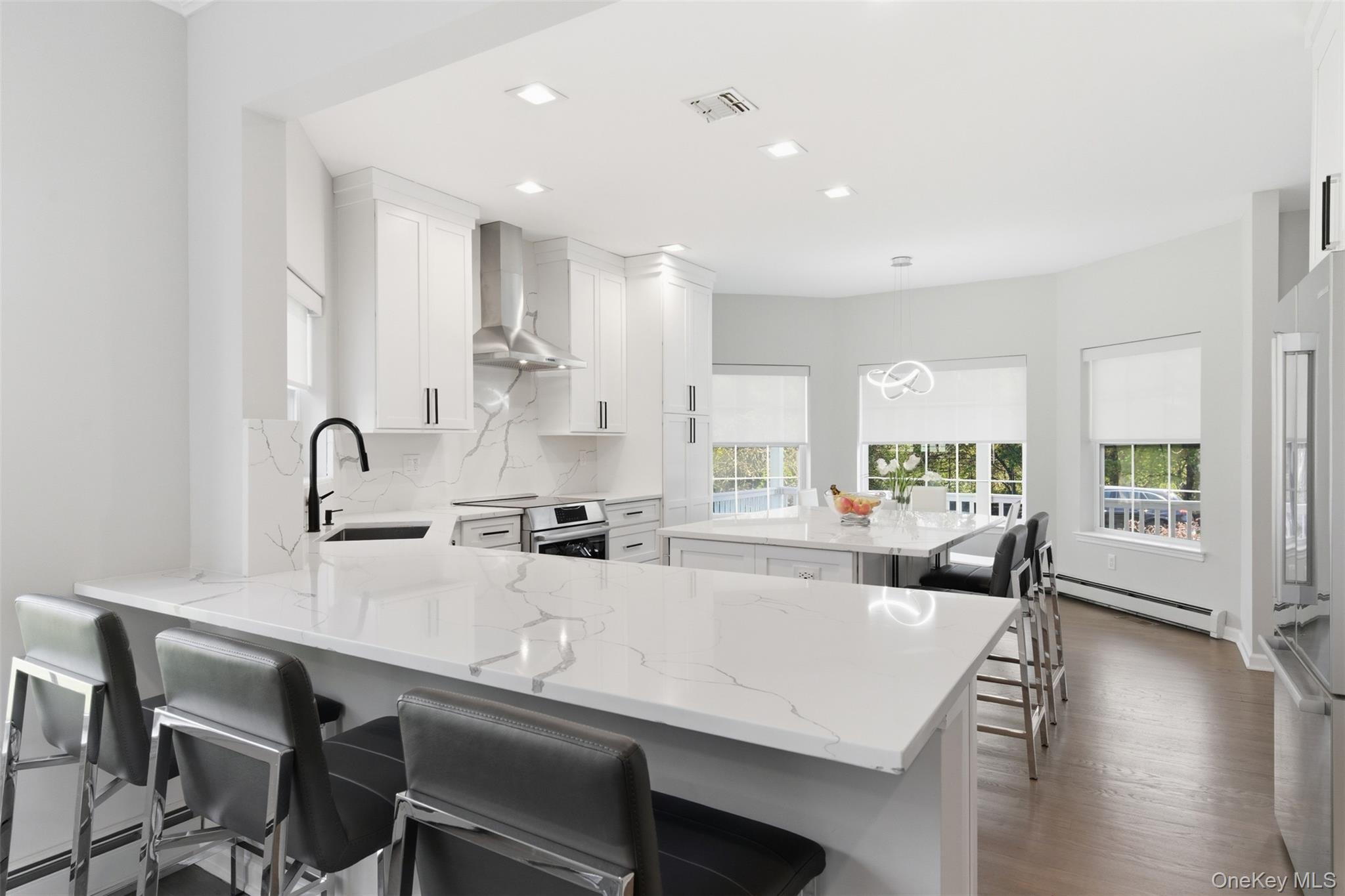 159 Rivendell Court Melville, NY 11747 - Photo 12 of 38 a large white kitchen with sink and cabinets