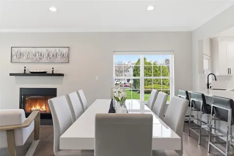 a view of a dining room with furniture and a potted plant