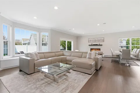 a living room with furniture a fireplace and kitchen view