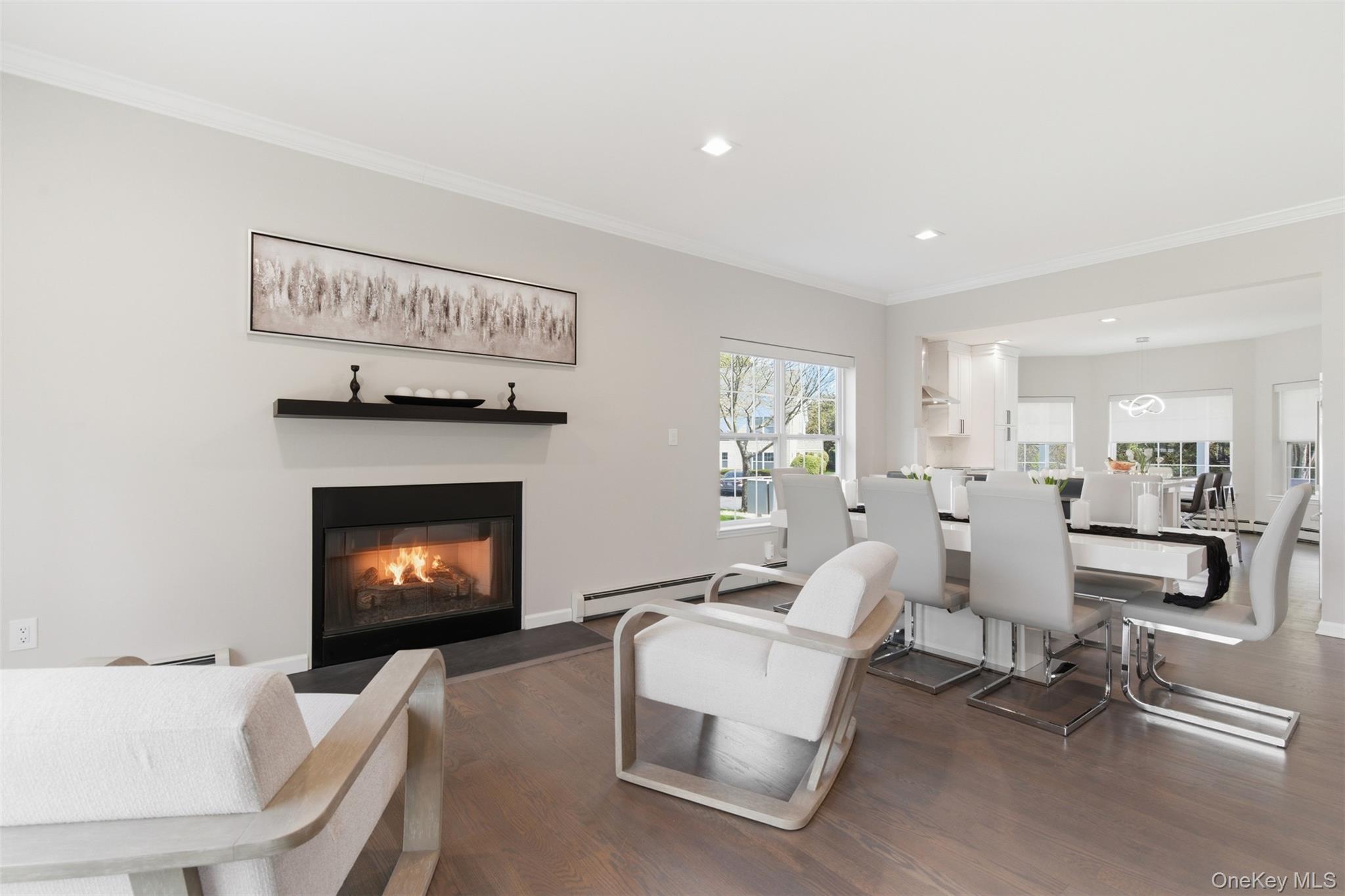 159 Rivendell Court Melville, NY 11747 - Photo 21 of 38 a living room with furniture a fireplace and kitchen view