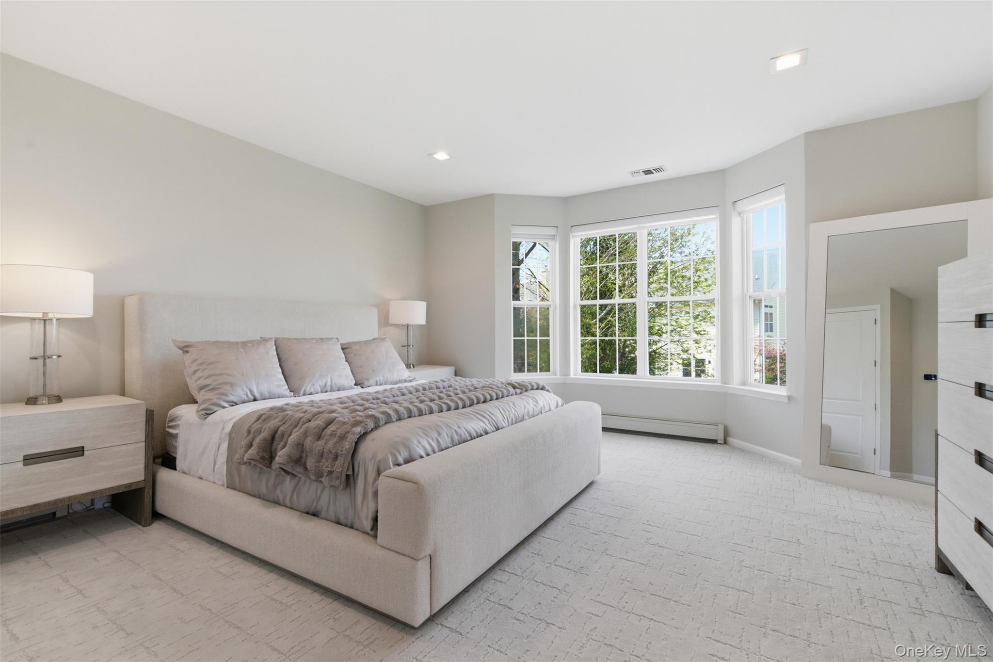 159 Rivendell Court Melville, NY 11747 - Photo 24 of 38 a spacious bedroom with a bed and a large window