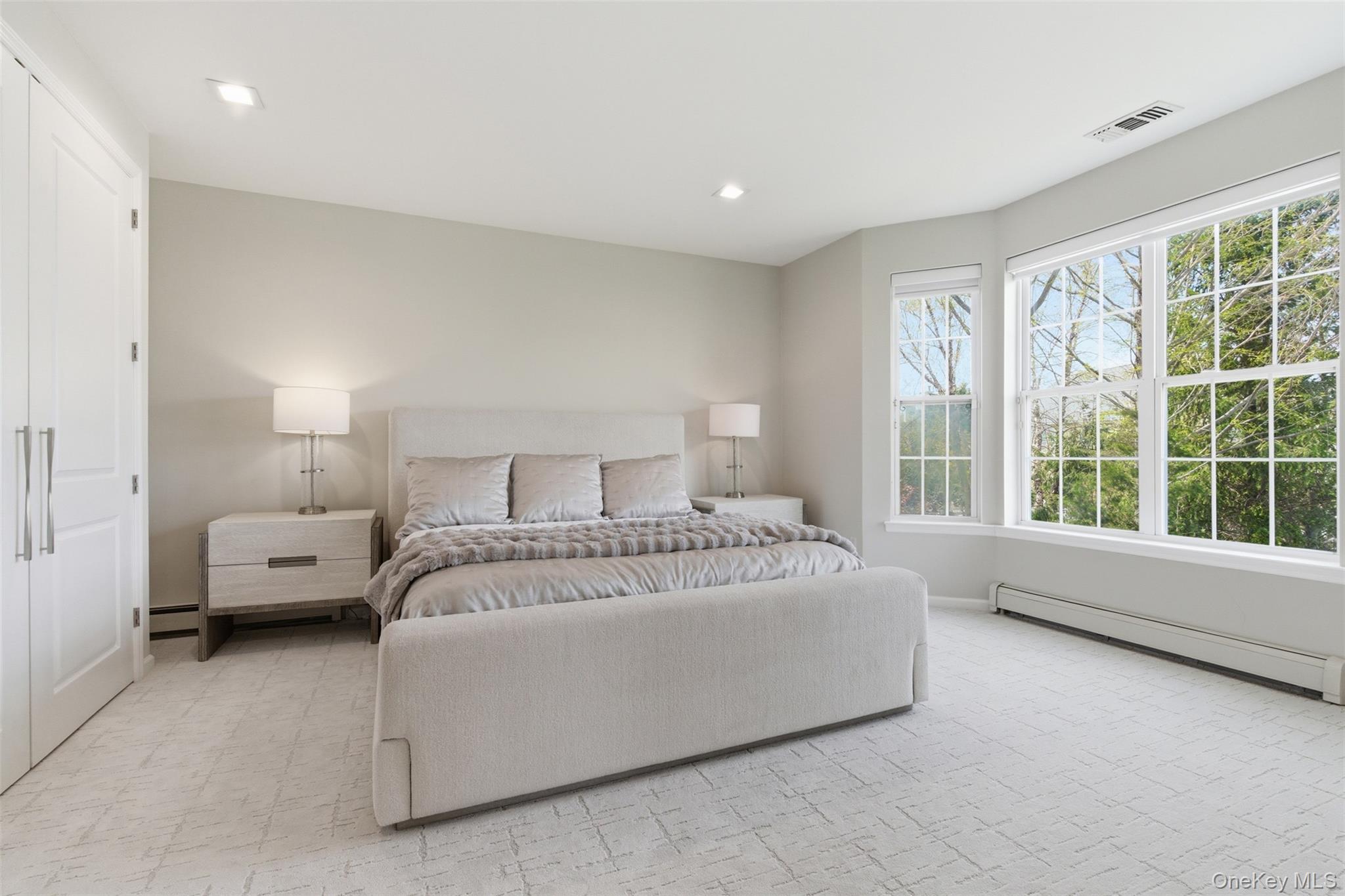 159 Rivendell Court Melville, NY 11747 - Photo 25 of 38 a spacious bedroom with a bed and a large window