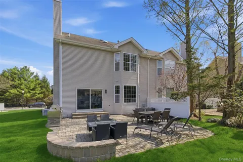 a view of a house with backyard sitting area and garden