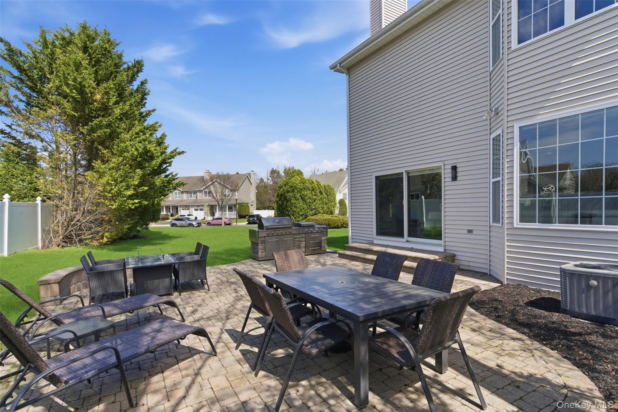 159 Rivendell Court Melville, NY 11747 - Photo 33 of 38 a view of a dinning table and chairs in backyard of the house