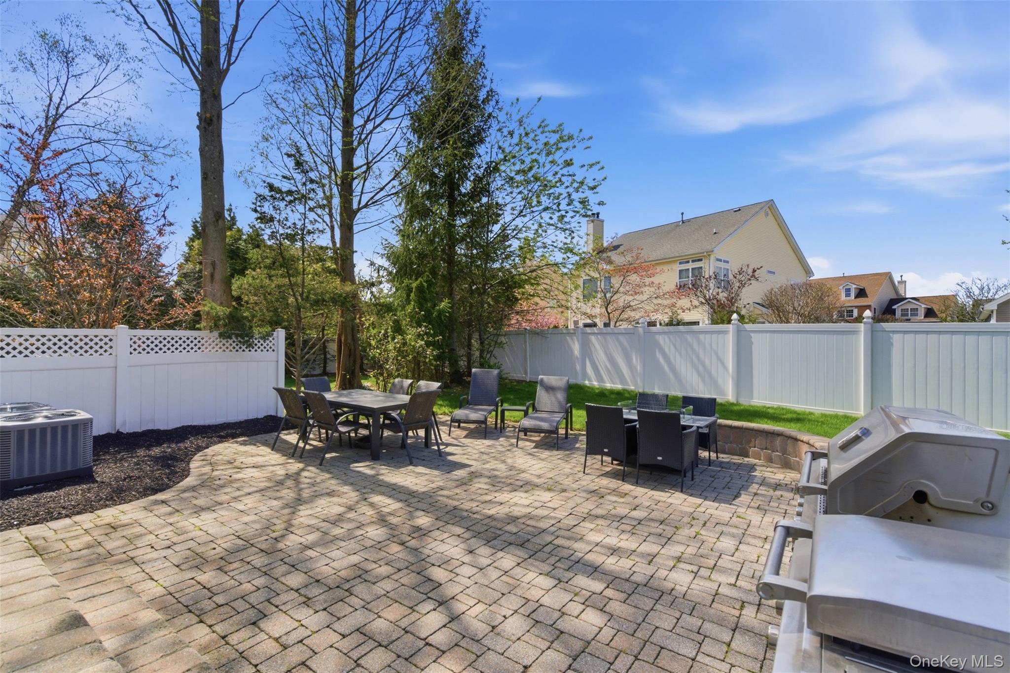159 Rivendell Court Melville, NY 11747 - Photo 35 of 38 a backyard of a house with barbeque oven and outdoor seating