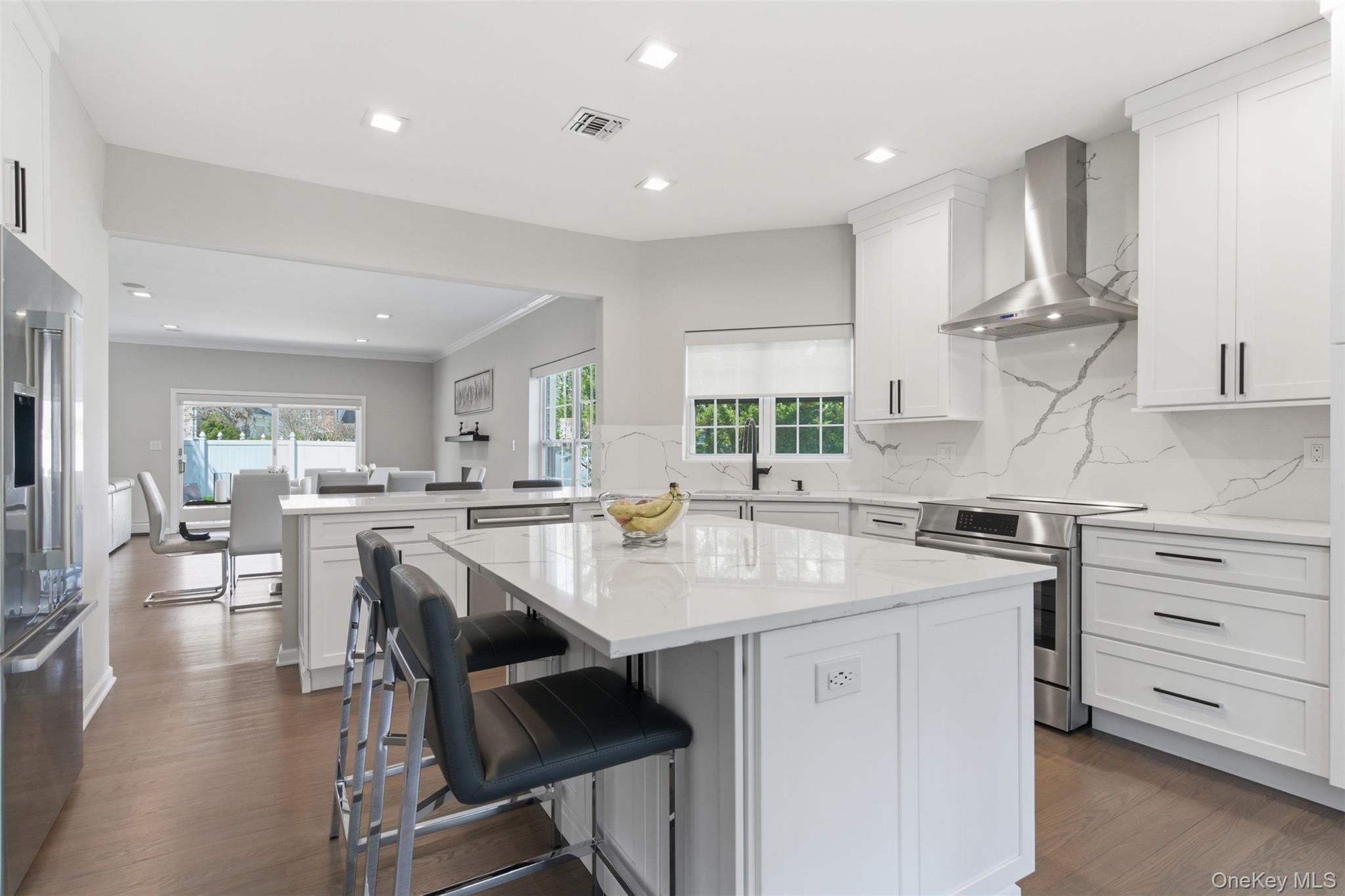 159 Rivendell Court Melville, NY 11747 - Photo 5 of 38 a kitchen with a table chairs stove and cabinets